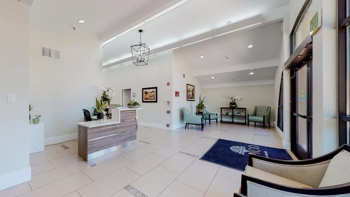 Lobby area featuring a reception desk and seating.