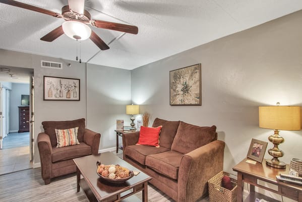 Cozy living room with seating and decorative items.