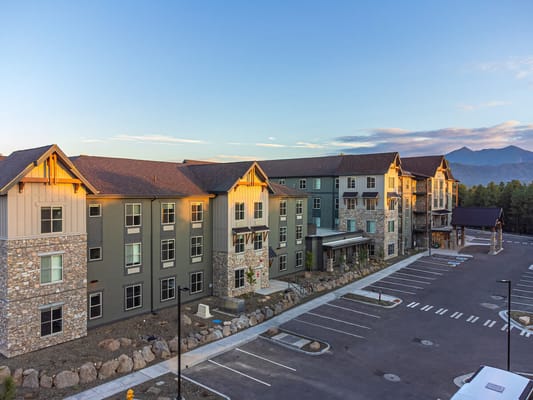 Exterior of The Bluffs of Flagstaff Senior Living facility at sunset