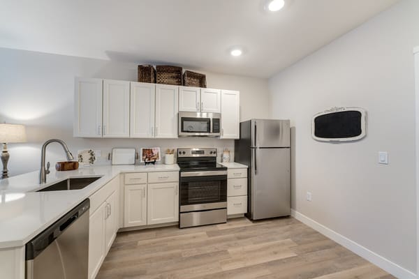 Bright and modern kitchen with stainless steel appliances and white cabinetry