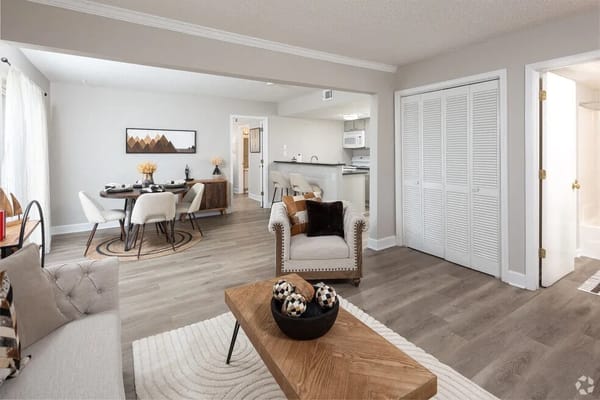 Bright living area with dining and kitchen access in a senior living facility