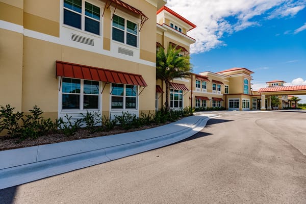 Exterior of The Gallery at Cape Coral showing windows and landscaping