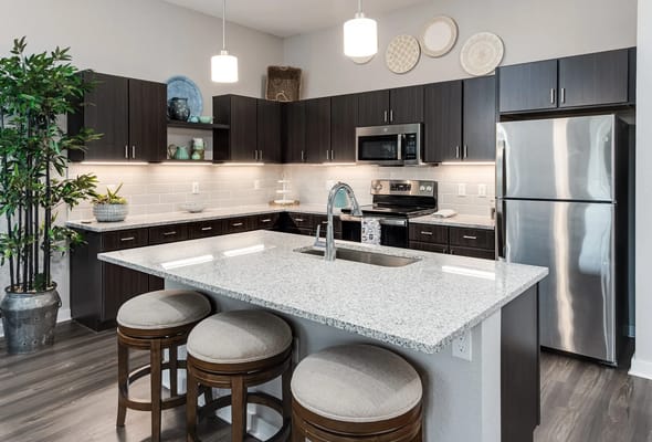 Spacious modern kitchen with granite countertop and stainless steel appliances