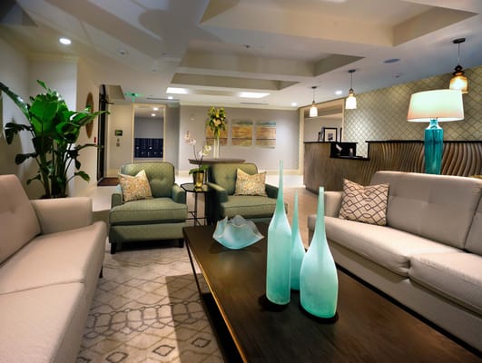 Cozy living room with green chairs and decorative vases