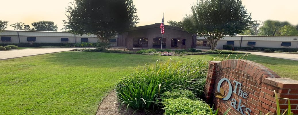 View of the front entrance and lawn at The Oaks Nursing & Rehabilitation