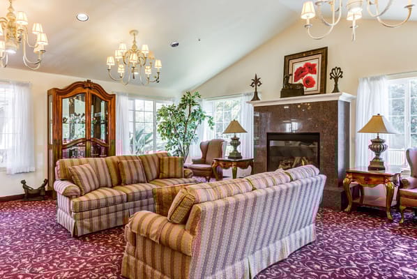 Comfortable living room with striped sofas and a fireplace