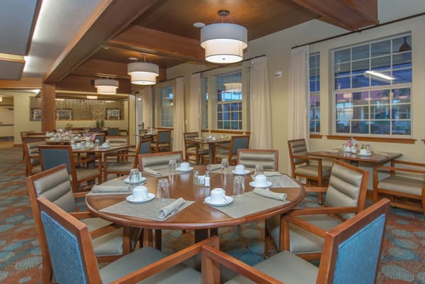 Bright dining room setup with tables and chairs at The Ranch Estates of Tucson.