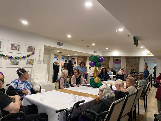 Residents and staff celebrating in a communal activity space