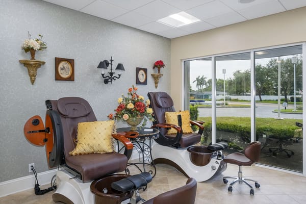 Manicure and pedicure chairs in a well-lit spa room