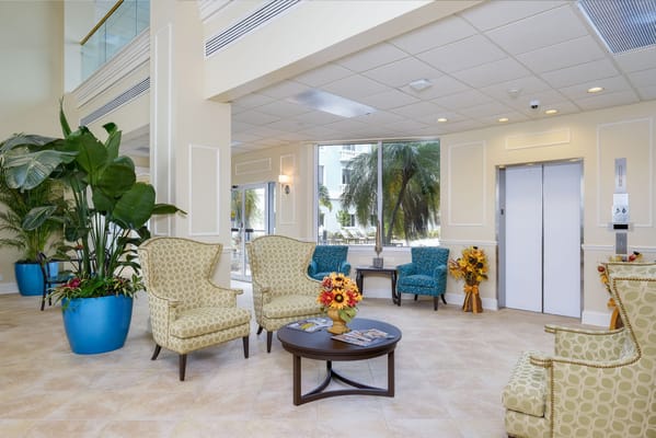 Cozy lobby area featuring patterned armchairs and a central table with floral decor.