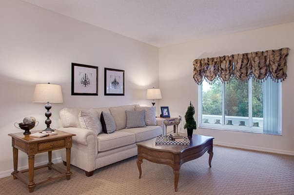 Elegant living room featuring a sofa, side tables, and decorative elements.