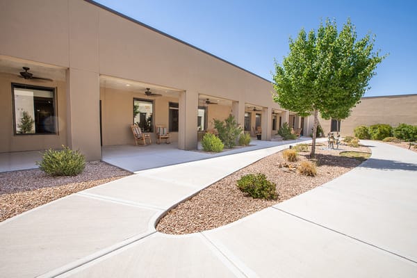 Pathway through courtyard with seating and greenery