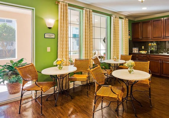 Cozy courtyard café with seated tables and floral arrangements