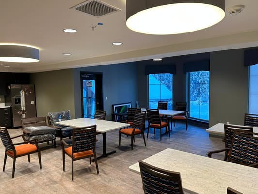 Bright common area with tables and chairs at Timber Creek Senior Living