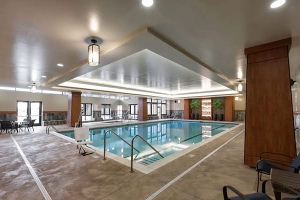 Indoor swimming pool area with seating