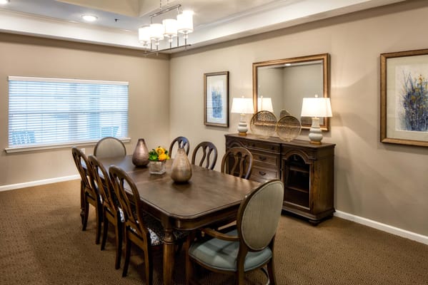 Well-furnished dining room with a wooden table and decorative vases