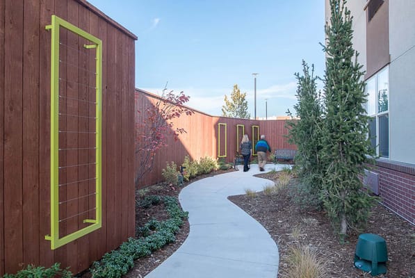 Residents walking in a serene garden pathway