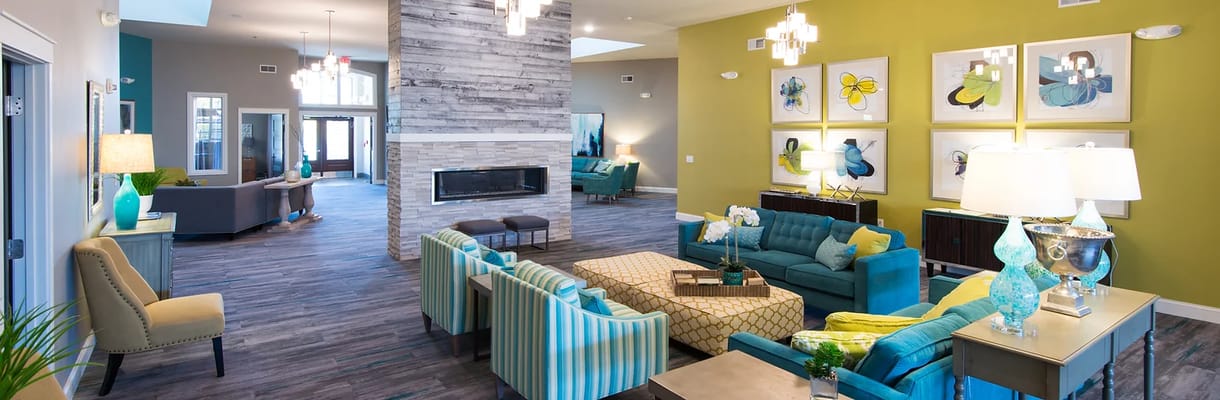 A spacious living room featuring colorful furniture and modern decor.