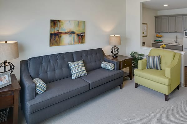 Comfortable living room with gray sofa and green armchair