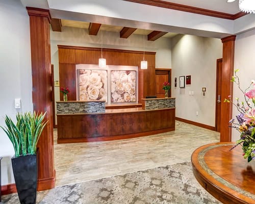 Welcoming reception area with floral decor and wooden accents