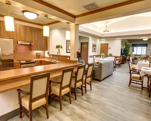 Bright kitchen and dining area with wooden furniture and a bar