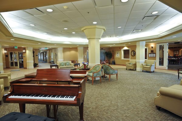 Interior view of a common area with a piano and seating