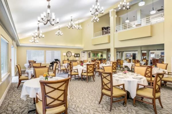 Dining room with elegant seating and chandeliers