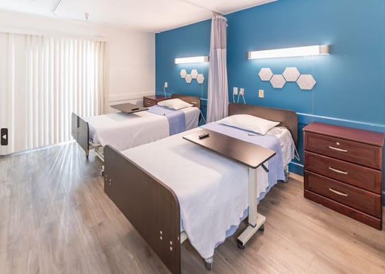 Spacious room with two beds and modern decor