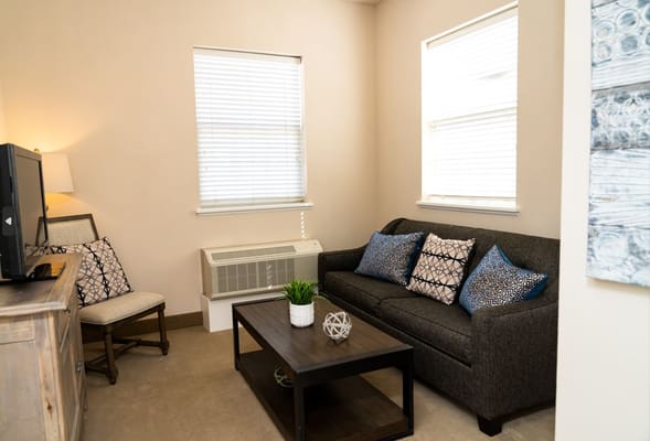 Cozy living room with sofa and TV at Avalon Assisted Living