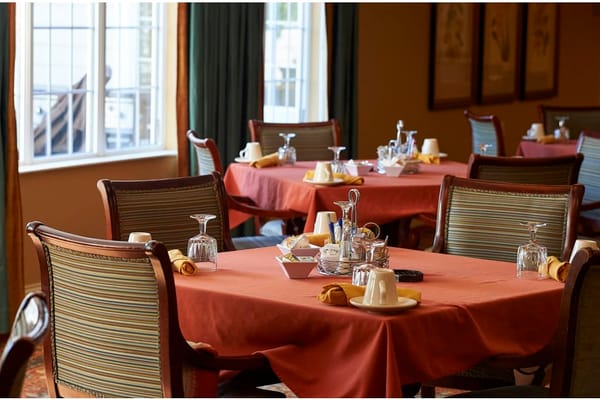 Set dining tables in a cozy dining room