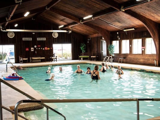 Residents participating in a swimming class in a warm pool