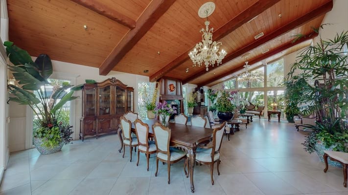 Elegant dining area with wooden beams and large windows