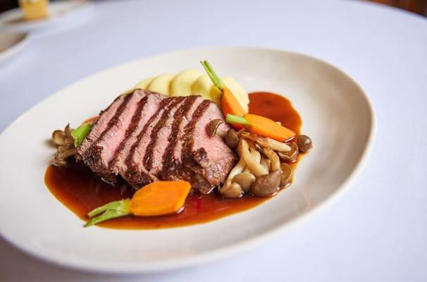 Plate of sliced sirloin with vegetables and mashed potatoes
