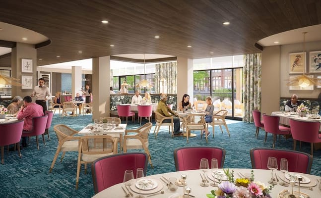 Bright and inviting dining area with residents enjoying meals