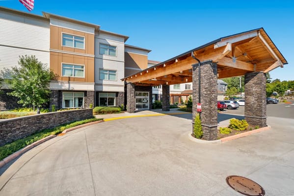 Entrance view of Mission Healthcare at Renton with a wooden overhang