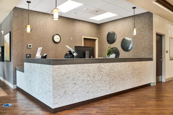 Modern reception desk with decor and clock