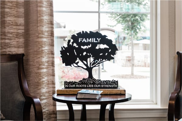 Decorative tree sculpture with a family theme in a common area