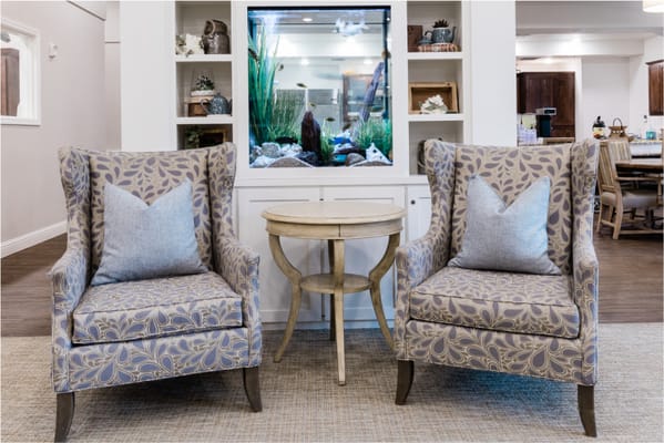 Cozy common area with chairs and an aquarium