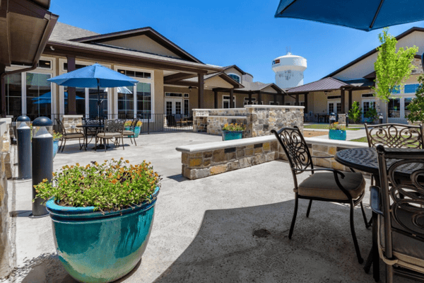 Outdoor seating area with potted plants and umbrellas
