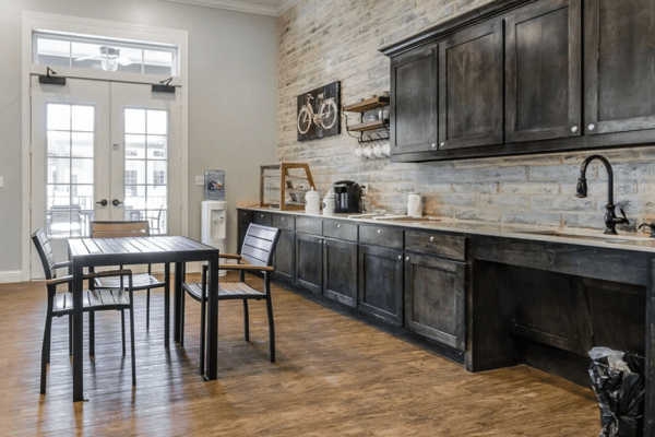 Interior view of a common area kitchen with seating