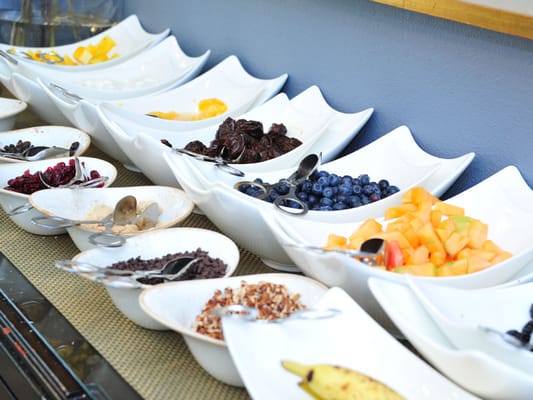 Assorted fruits and toppings in a dining area
