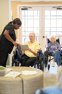 Staff assisting residents in a common area