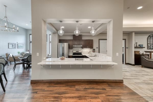 Bright, modern kitchen area with seating and appliances
