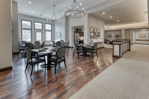 Dining area with tables and chairs in a bright interior
