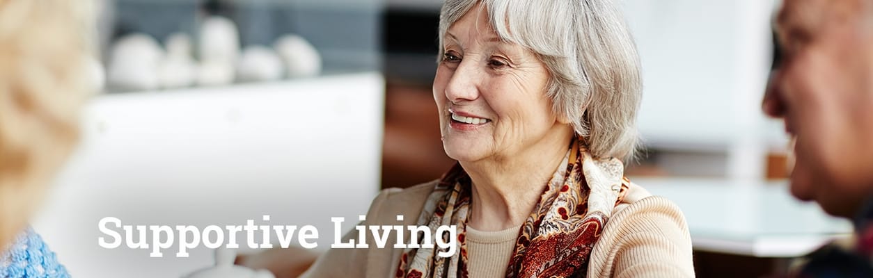 A smiling resident participating in a conversation