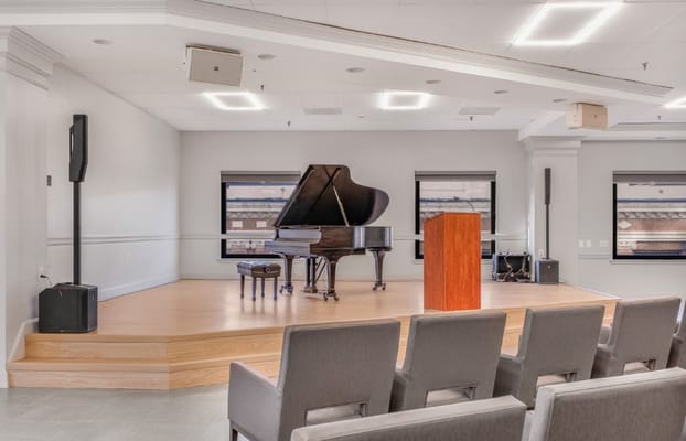 Interior view of a performance space with a grand piano