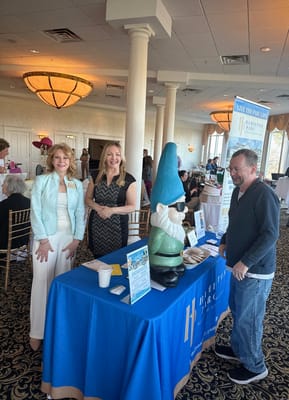 Residents and staff at a facility event with a gnome statue