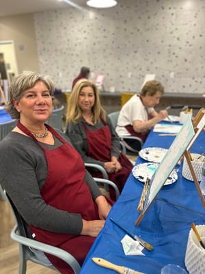 Residents painting in an indoor activity room