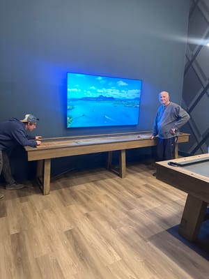 Residents interacting in a common area with a game table