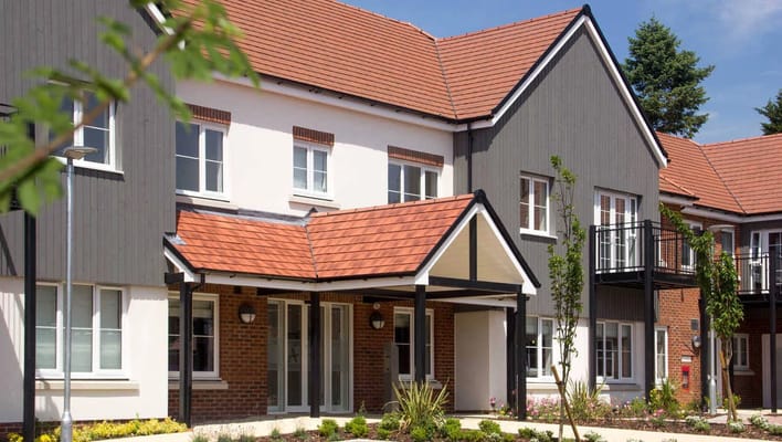 Exterior view of a senior living facility with a garden